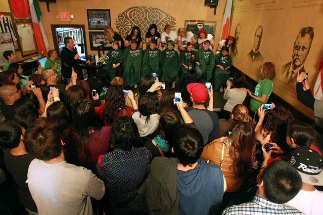 Supporters watch their friends and family members have their heads shaved during the St. Baldrick's fundraiser for cancer Saturday, March 1, 2014 at McMillan's Irish Pub.
